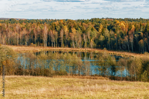 Autumn color landscape of European plains with hills and lowlands, marshes, meadows and forests.