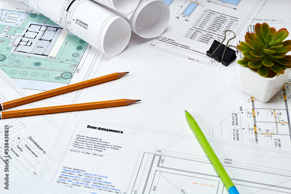 Working tools and drawings of the designer on a white background. Construction of houses, drawing, interior design. Working tools and drawings of the designer on a white background. Construction of houses, drawing, interior design.