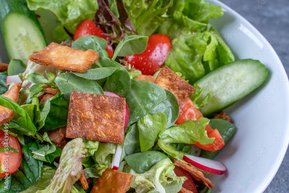 Healthy Caesar salad with croutons, Green salad with fresh vegetables and croutons.