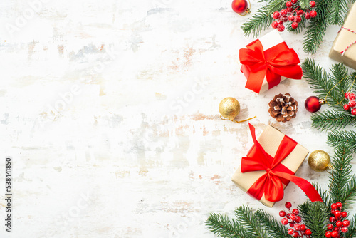 Christmas gift boxes with holiday decorations at white background. Flat lay composition.