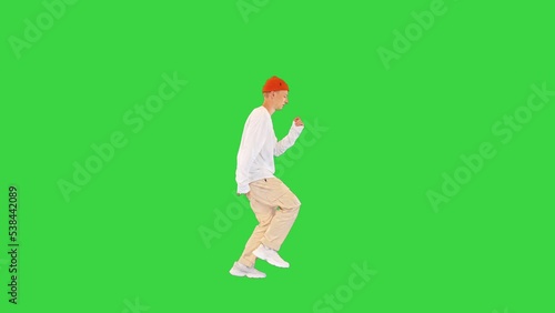 Cool young breakdancer walking and dancing on a Green Screen, Chroma Key.