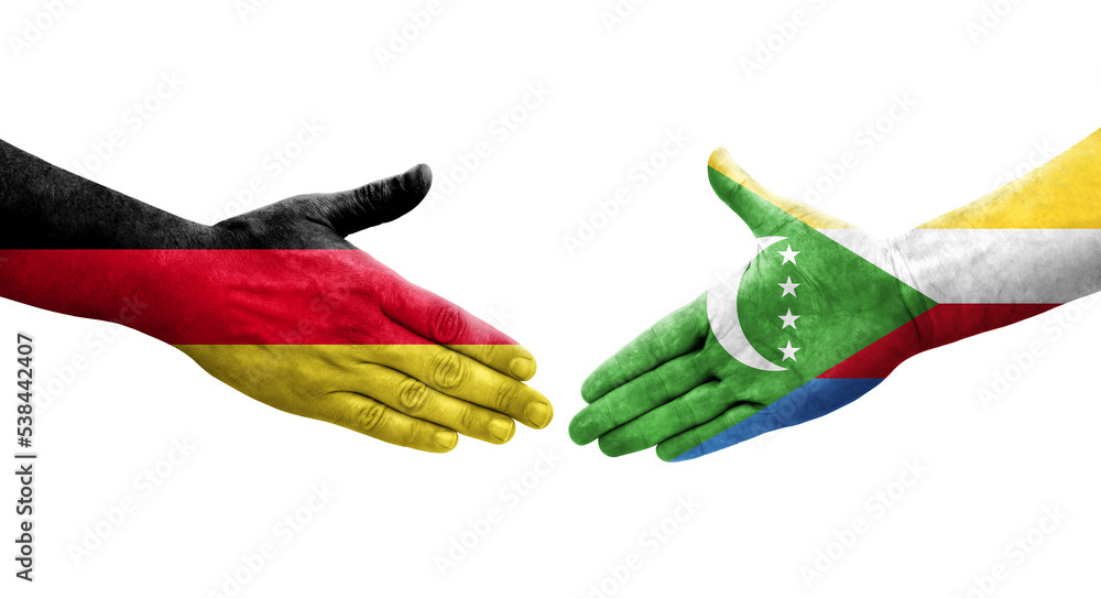 Handshake between Comoros and Germany flags painted on hands, isolated transparent image.