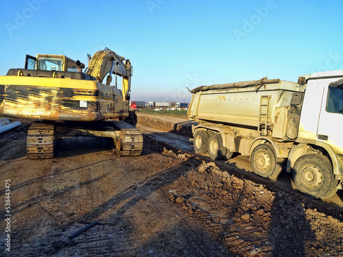 Truck and Excavator working at construction site