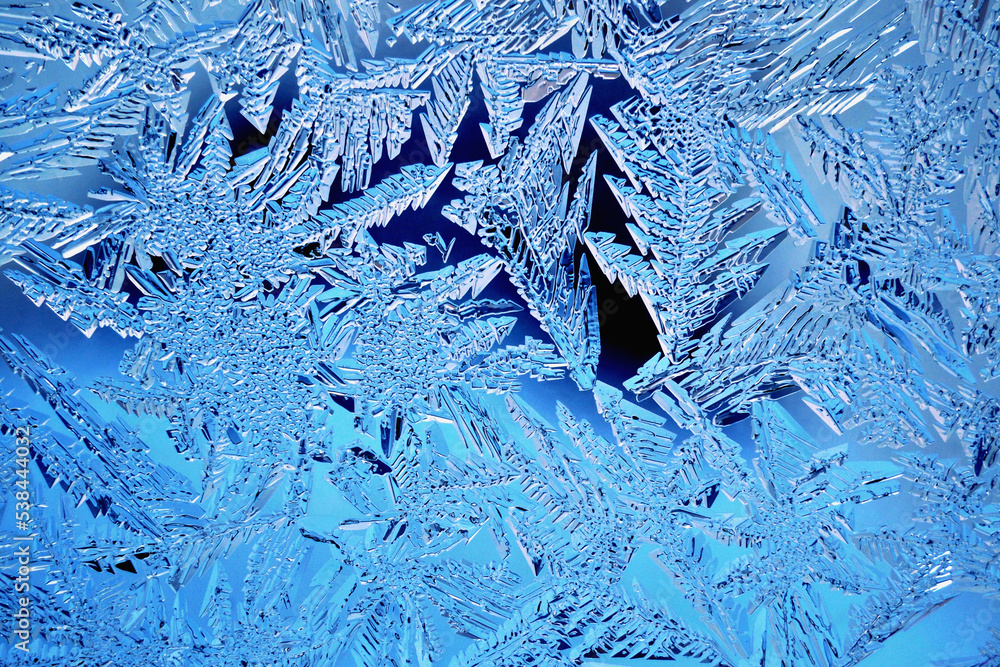 Abstract Christmas wallpaper. Ice crystals on frozen window glass ...