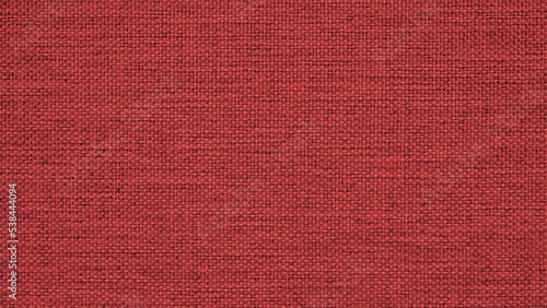Dark red woven surface close-up. Textile texture similar to linen fabric. Net background. Textured braided wallpaper. Macro