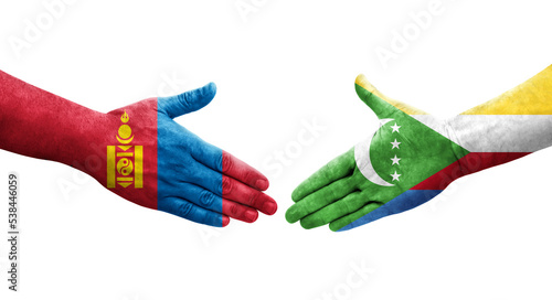 Handshake between Comoros and Mongolia flags painted on hands, isolated transparent image.