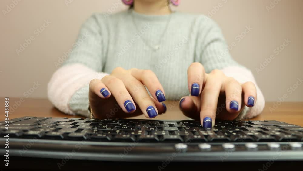 Young girl typing on a computer keyboard Young girl typing on a computer keyboard