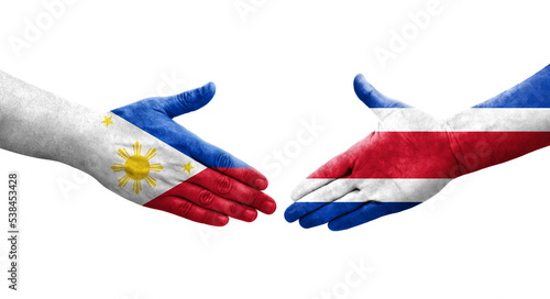 Handshake between Costa Rica and Philippines flags painted on hands, isolated transparent image.
