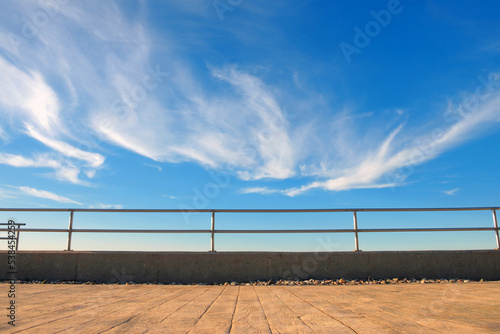 Foto Metal barrier or railings between promenade and blue sky
