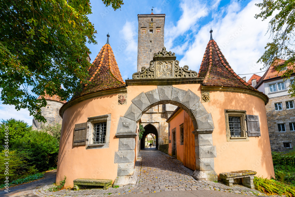 The Western town gate Burgtor in the picturesque medieval German town of Rothenburg ob der Tauber, Germany, one of the stops along the Romantic Road of Bavaria.