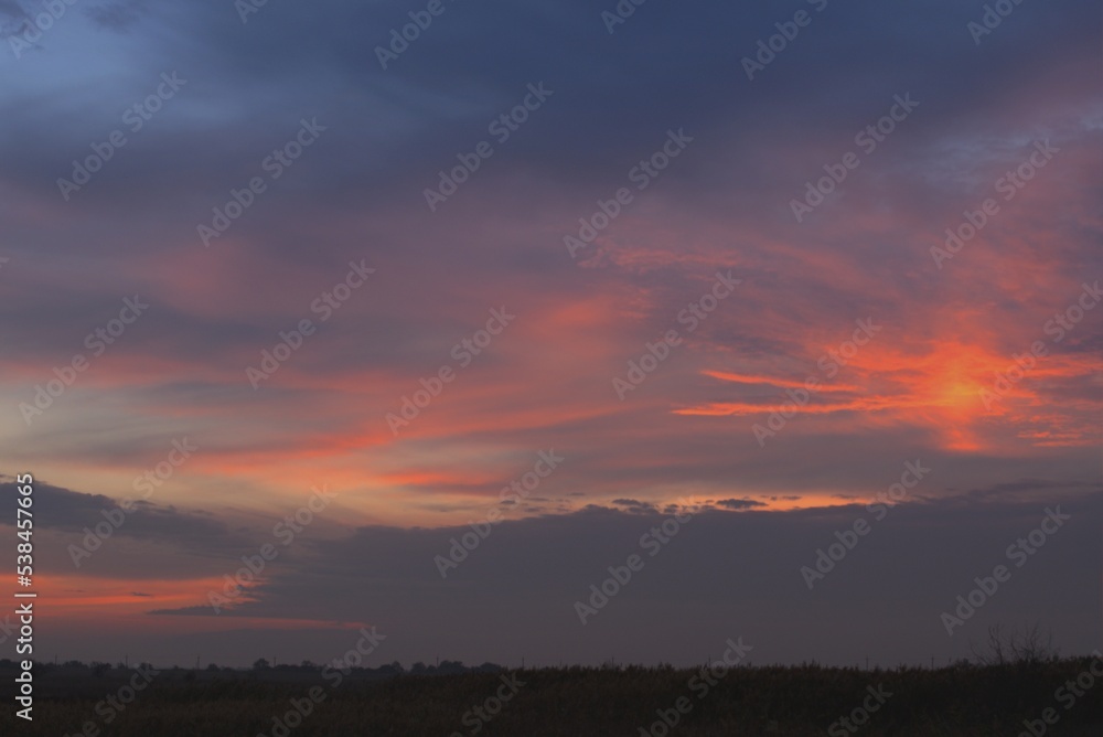 Autumn pink sunset, beautiful high sky, evening landscape of an endless field, Krasnodar region, Russia Autumn pink sunset, beautiful high sky, evening landscape of an endless field, Krasnodar region, Russia