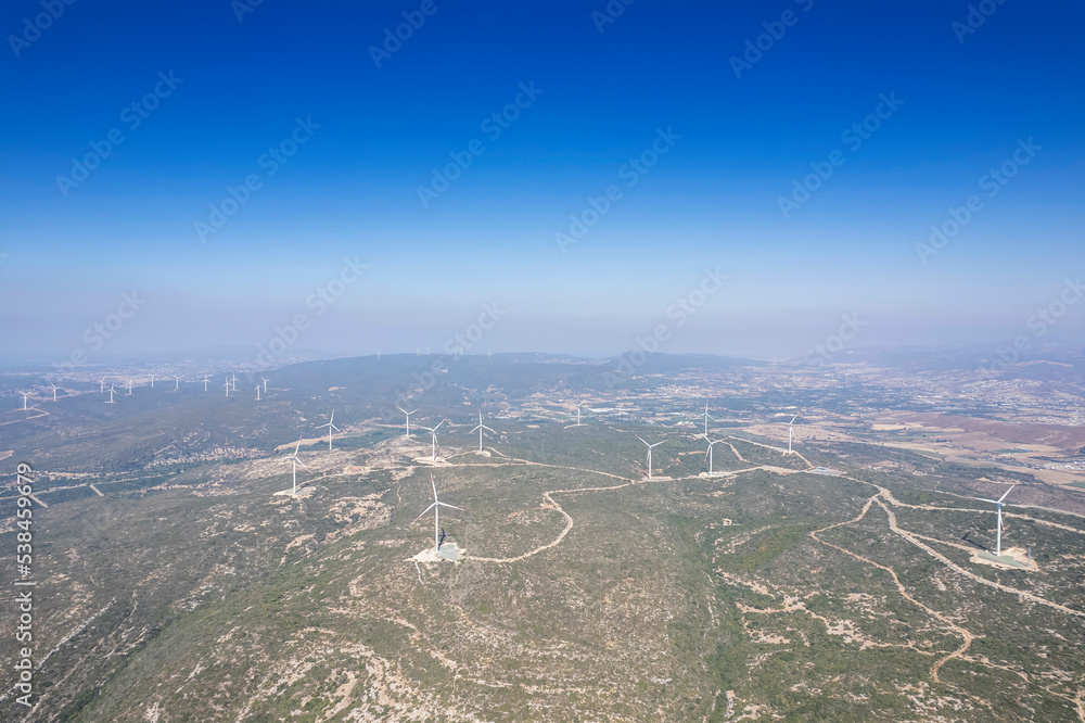 Aerial photo of a nice windmill on a green meadow with white clouds in the blue sky. Aerial photo of a nice windmill on a green meadow with white clouds in the blue sky.
