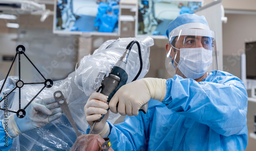 Bild auf Leinwand Team of doctor perform total hip arthroplasty replacement surgery in osteoarthritis patient inside the operating room
