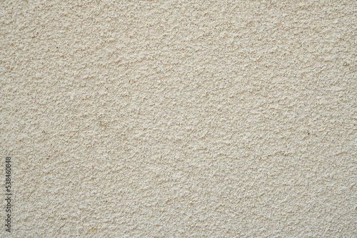 Textured beige plaster on the wall.