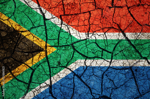 Dry soil pattern on the flag of South Africa. Country with drought concept. Water problem. Dry cracked earth country.	
