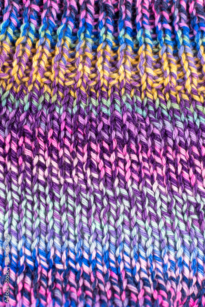 hand knitting fabric texture background in colours of purple and green hand knitting fabric texture background in colours of purple and green