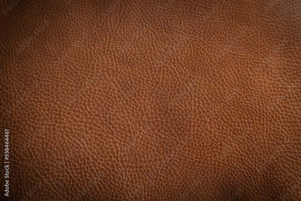 The texture of the leather product. Brown decorative background. The texture of the leather product. Brown decorative background.