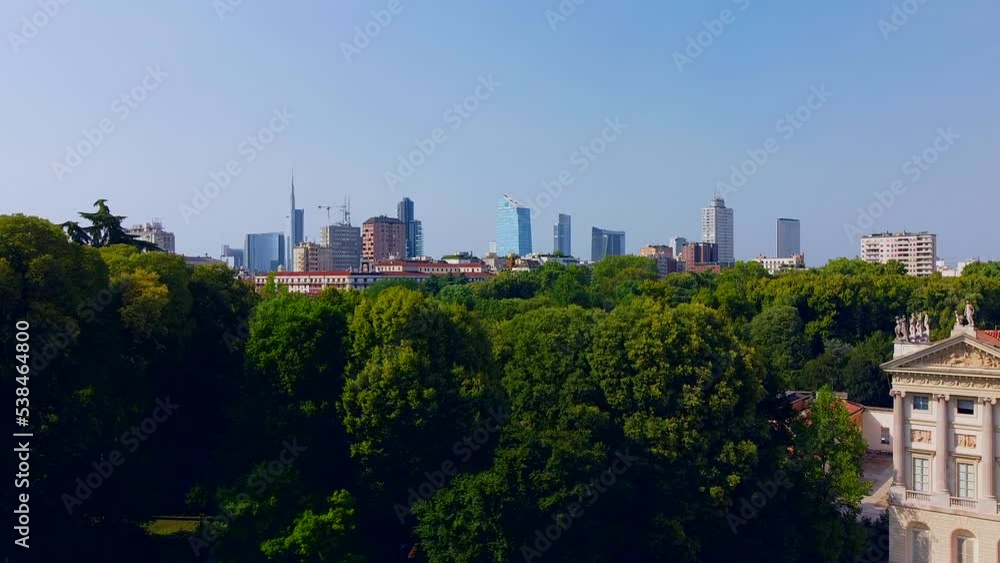 Aerial view of autumn trees in Giardini Indro Montanelli park and the skyline with new skyscrapers. View of modern business offices. Ecology. Clouds over the city. Green Planet. Milan. Italy, Aerial view of autumn trees in Giardini Indro Montanelli park and the skyline with new skyscrapers. View of modern business offices. Ecology. Clouds over the city. Green Planet. Milan. Italy,