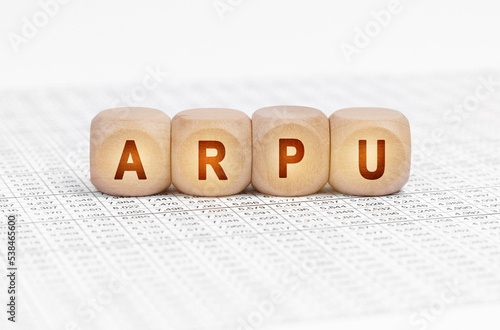 On the table with documents are wooden cubes with the inscription - ARPU photo