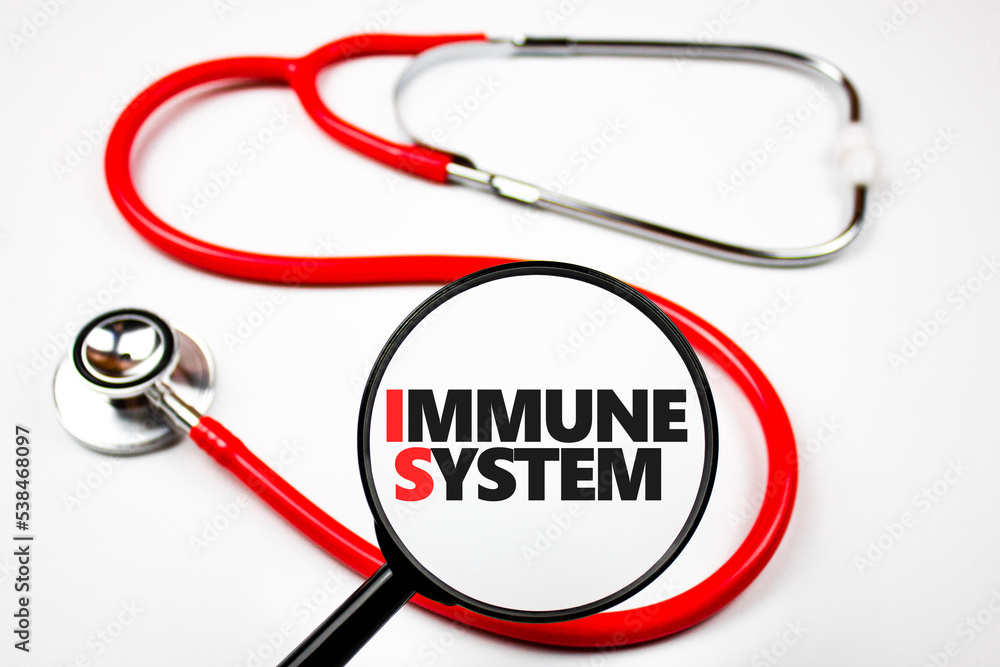 Immune system word through a magnifying glass on a doctor's desk. Immune system word through a magnifying glass on a doctor's desk.