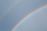 Beautiful view of double rainbow in sky on grey day