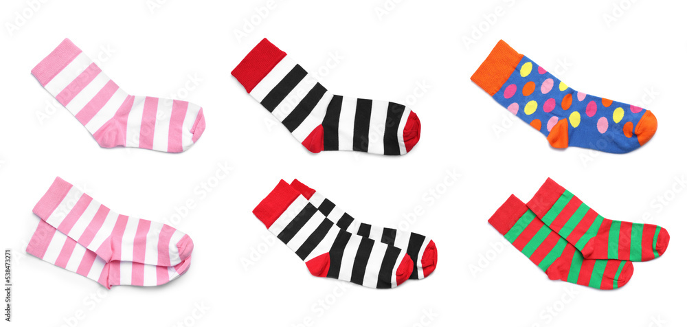 Set with pairs of colorful striped socks on white background, top view. Banner design Set with pairs of colorful striped socks on white background, top view. Banner design