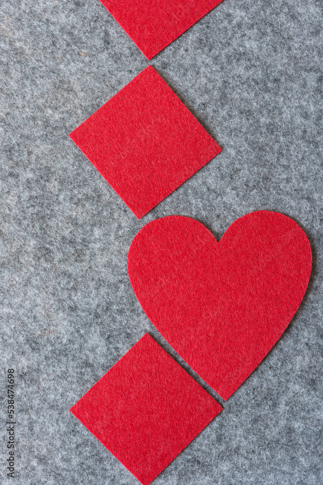 red felt heart and diamond or square shapes on gray felt red felt heart and diamond or square shapes on gray felt