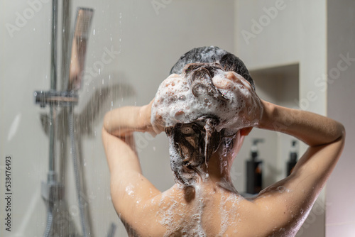 Woman bathing and washing her hair relaxed..