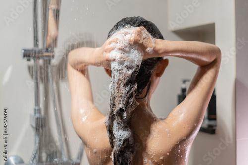 Woman bathing and washing her hair relaxed..