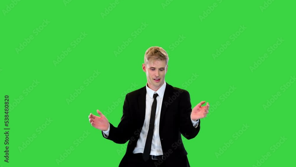 Handsome relaxed guy in office suit dances clapping his hands on a Green Screen, Chroma Key. Handsome relaxed guy in office suit dances clapping his hands on a Green Screen, Chroma Key.