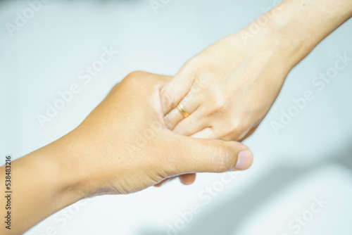 Someone gently holds the hands of the girl isolated with white background