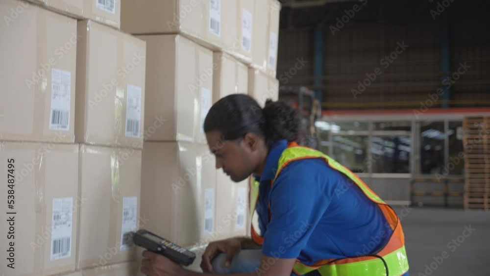 Young man scanning barcode to package box with transportation and distribution in the warehouse at factory, staff man working and inspection to freight, logistic and cargo, industrial concept. Young man scanning barcode to package box with transportation and distribution in the warehouse at factory, staff man working and inspection to freight, logistic and cargo, industrial concept.