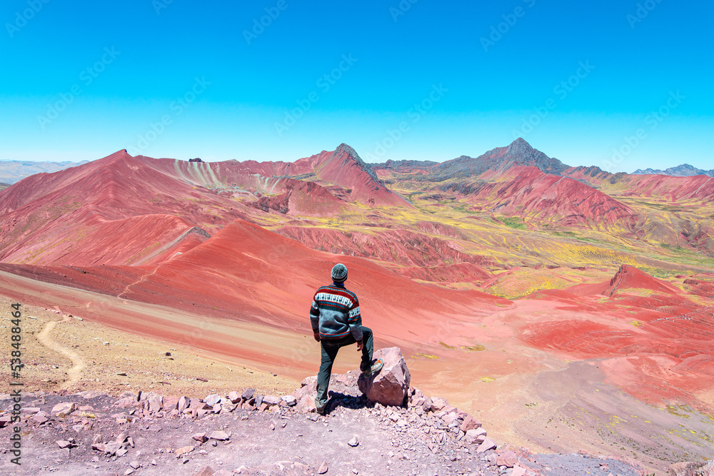 a man is taking a photo in rainbow mountain, peru