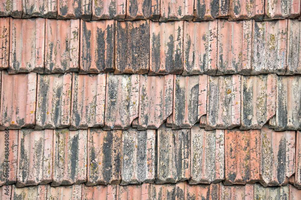 Closeup surface of old weathered ceramic tiles covering building roof Closeup surface of old weathered ceramic tiles covering building roof