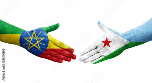 Handshake between Djibouti and Ethiopia flags painted on hands, isolated transparent image. photo