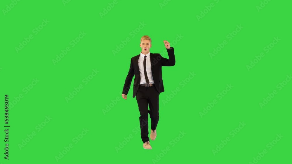 Witty guy in black office suit performs funny dance and sits on a twine in the end on a Green Screen, Chroma Key. Witty guy in black office suit performs funny dance and sits on a twine in the end on a Green Screen, Chroma Key.