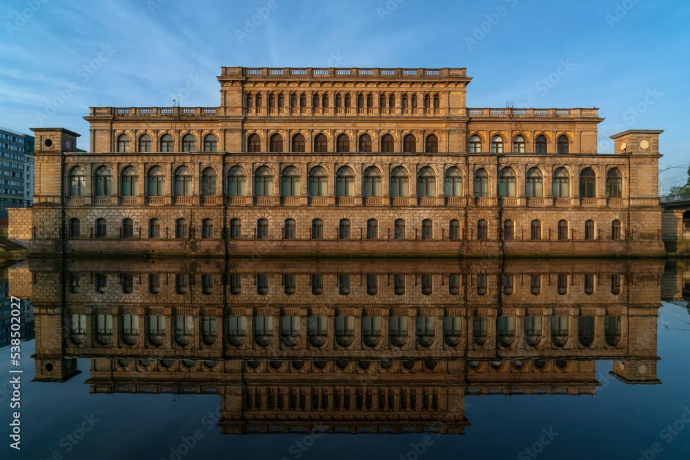 View of the Regional Museum of Fine Arts in the former building of the Koningsberg Stock Exchange from Pregolya River with reflection in the water on a sunny summer day, Kaliningrad, Russia