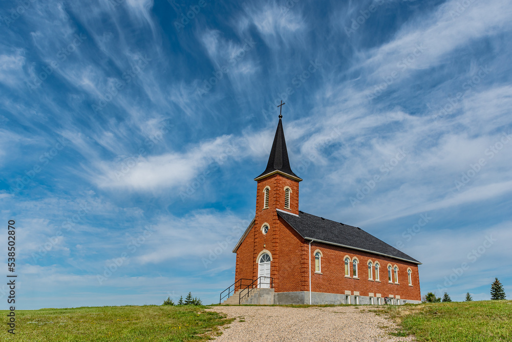 Blue sky and clouds over St. Johns Lutheran Church in Edenwold, near Regina, SK 