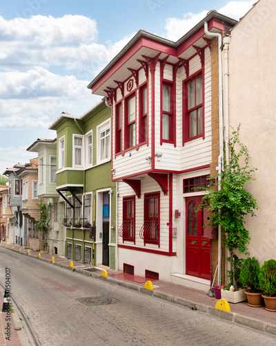 Fototapeta Naklejka Na Ścianę i Meble -  Cobblestone alley, with beautiful old colorful traditional wooden houses on the side, suited in Fatih district, Istanbul, Turkey, in a summer day