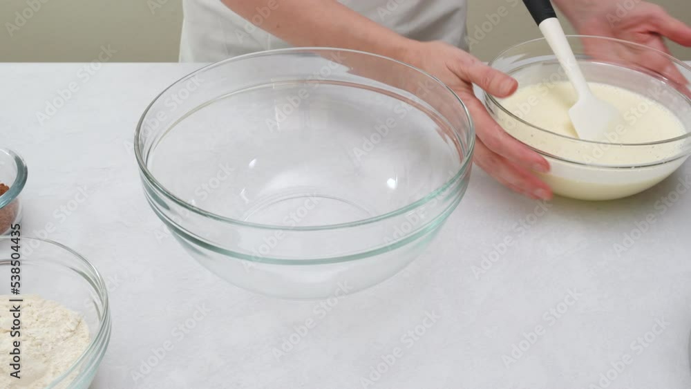 Chocolate cake step by step recipe. Mixing dry ingredients in a glass bowl, close up view Chocolate cake step by step recipe. Mixing dry ingredients in a glass bowl, close up view