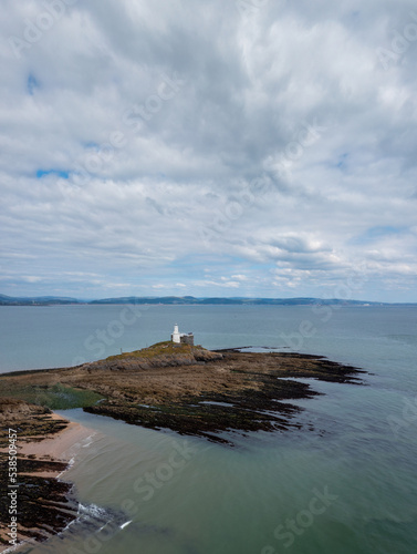 view of the Mumbles Lighthouse in Swansea Bay at low tide
