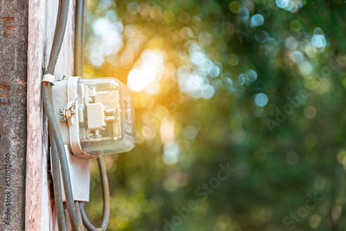 Kilowatt hour meter on blur sky background. Electric power meter measuring power usage. Electricity Monitoring Equipment. measument energy consumption. photo