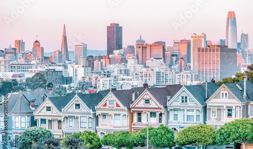 Painted Ladies Victorian houses in Alamo Square and a view of the San Francisco skyline and skyscrapers. Photo processed in pastel colors