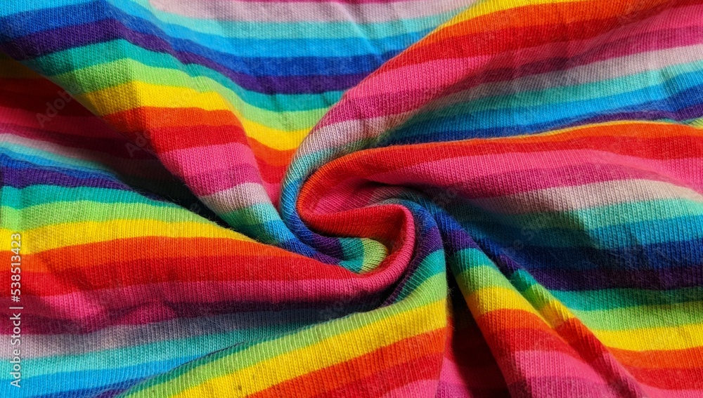 selective focus rainbow-patterned fabric on a yellow background, rainbow-colored background with copy space selective focus rainbow-patterned fabric on a yellow background, rainbow-colored background with copy space
