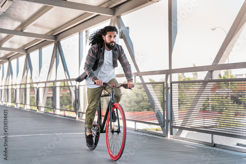 Hipster Man Riding his Bike