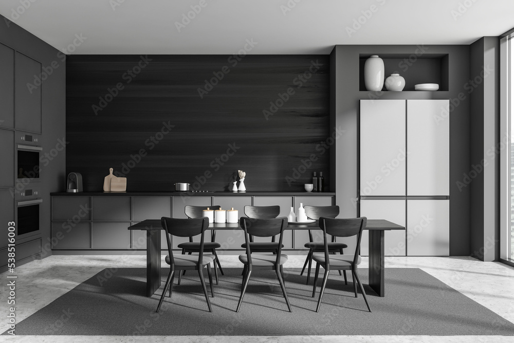 Stylish kitchen interior with dining table and seats, kitchenware and window