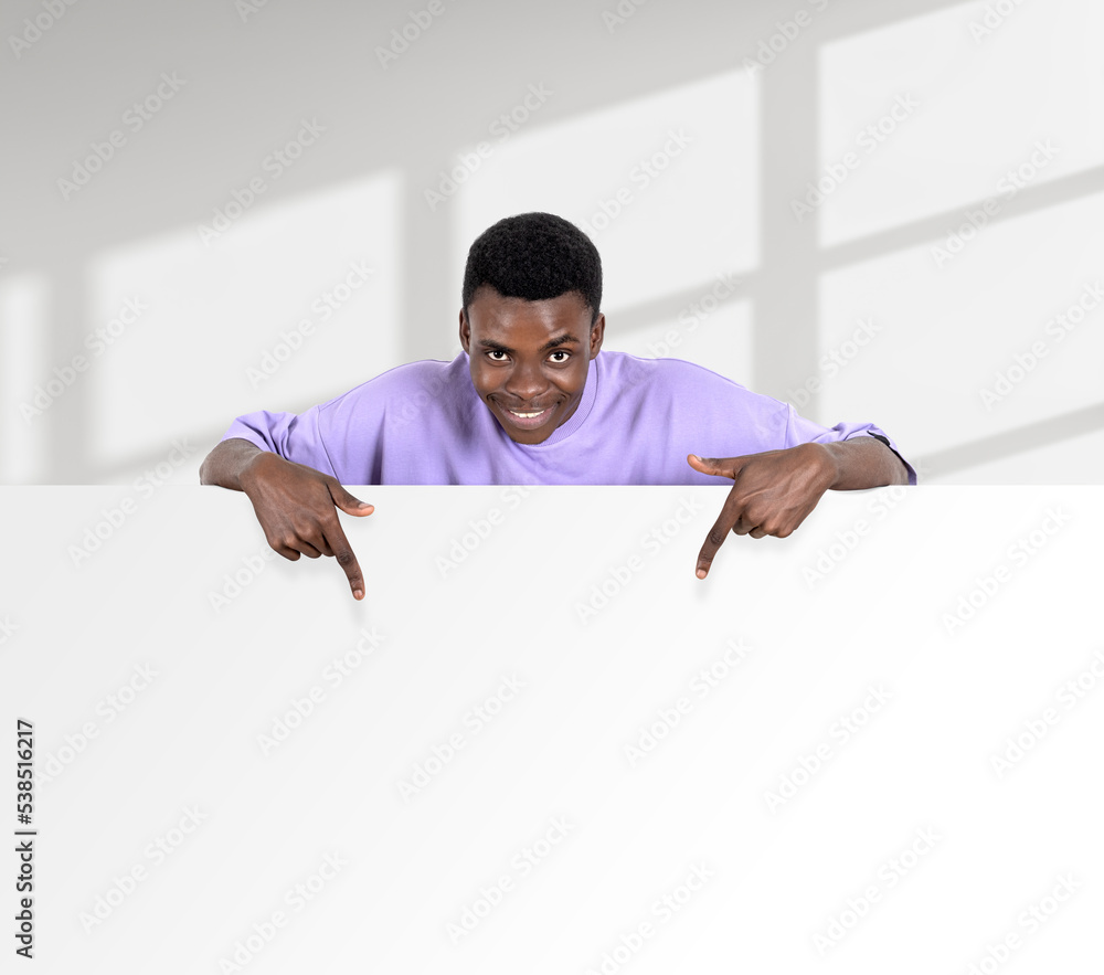 African happy man fingers pointing at mockup whiteboard on light background African happy man fingers pointing at mockup whiteboard on light background