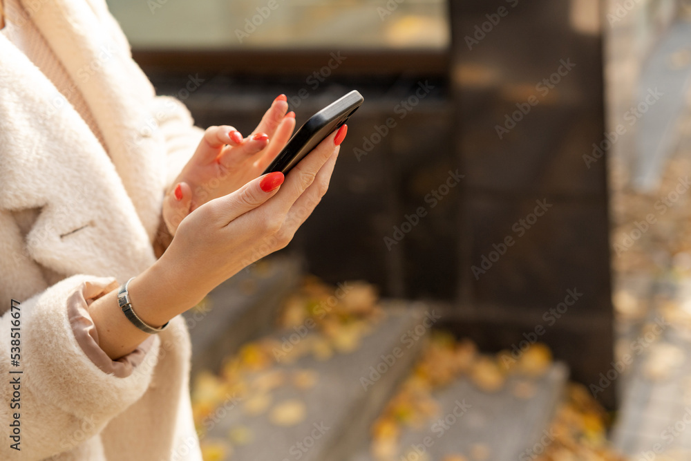 Woman calls a taxi using a mobile phone. Woman calls a taxi using a mobile phone.