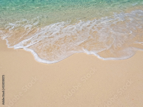 Natural scenery of beautiful tropical beaches and sea on a clear day. Light blue ocean waves on clean sandy beach. © MarutStudio
