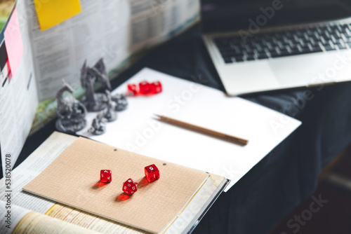 Behind of dungeon master screen with dice and miniatures for role playing tabletop and board games hobby photo